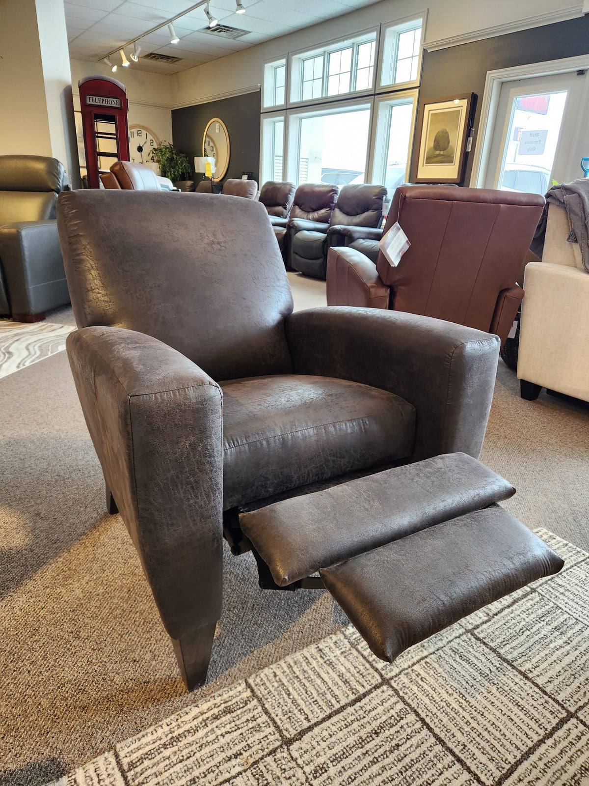 The La-z-boy 431 Scarlett High-Leg Recliner in dark brown leather features an extended footrest and elegant design.