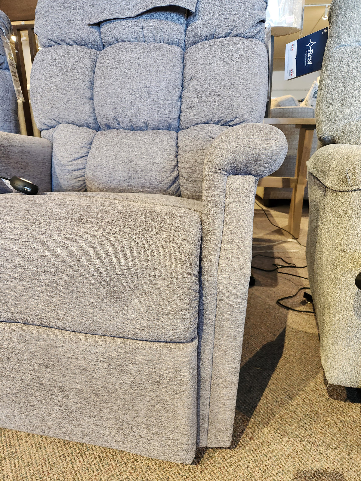 Light gray Golden Aurora PL480 Power Lift Chair with textured fabric, shown indoors on a carpeted floor.