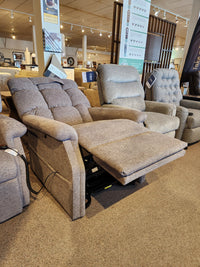 A Golden Aurora PL480 Power Lift Chair is fully extended in a showroom with other chairs displayed in the background.