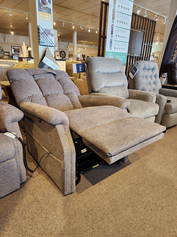A Golden Aurora PL480 Power Lift Chair is fully extended in a showroom with other chairs displayed in the background.