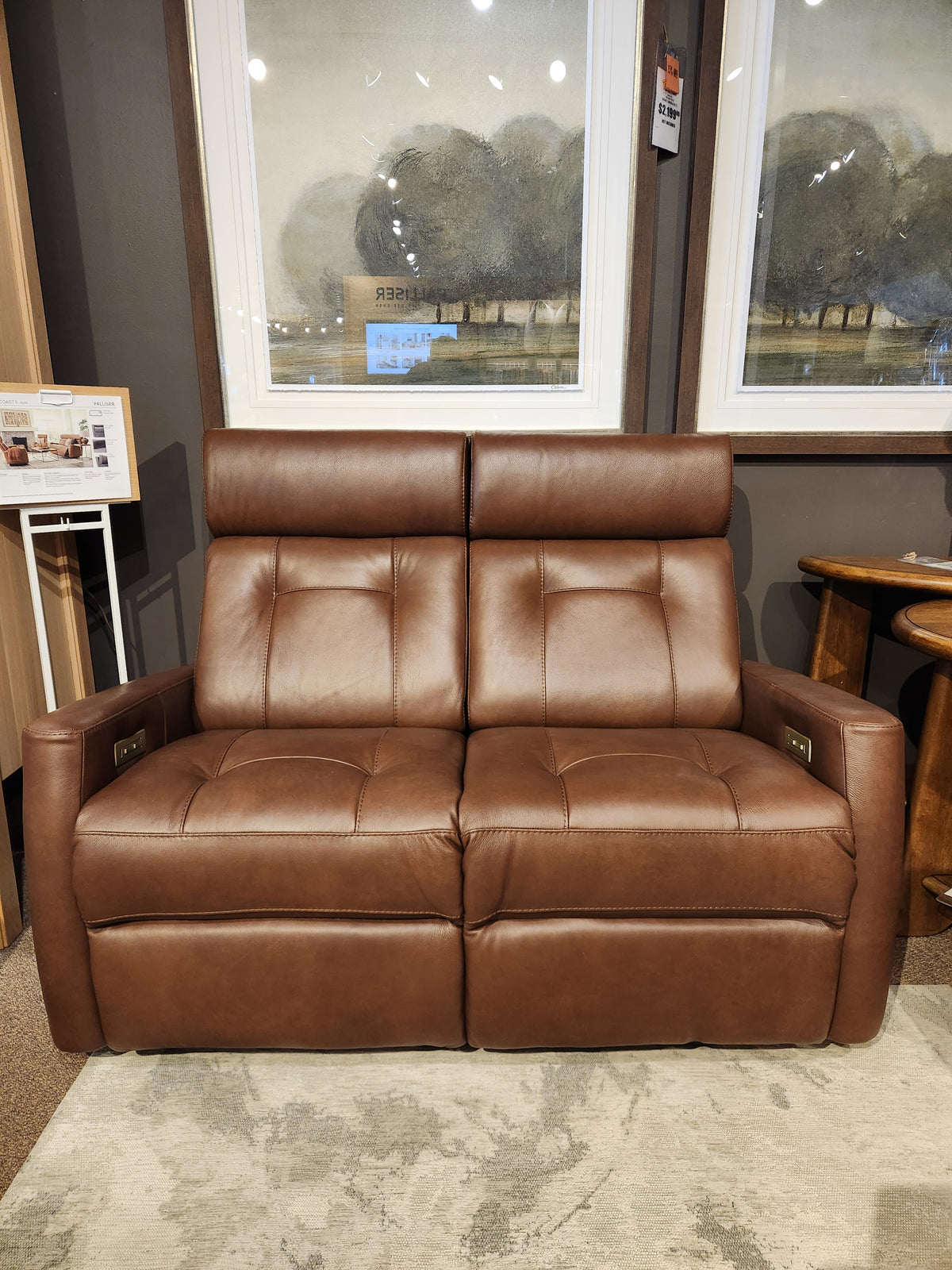 Palliser 42204 West Coast Power Reclining Loveseat with Headrest, shown with framed art in the background.