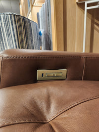 Close-up of the Palliser 42204 West Coast Power Reclining Loveseat with brown leather, USB port, and button controls.