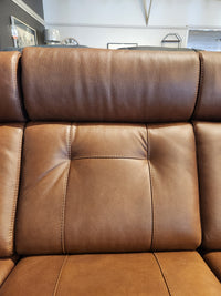 Close-up of the Palliser 42204 West Coast Power Reclining Sofa's leather backrest with stitching and tufted buttons.