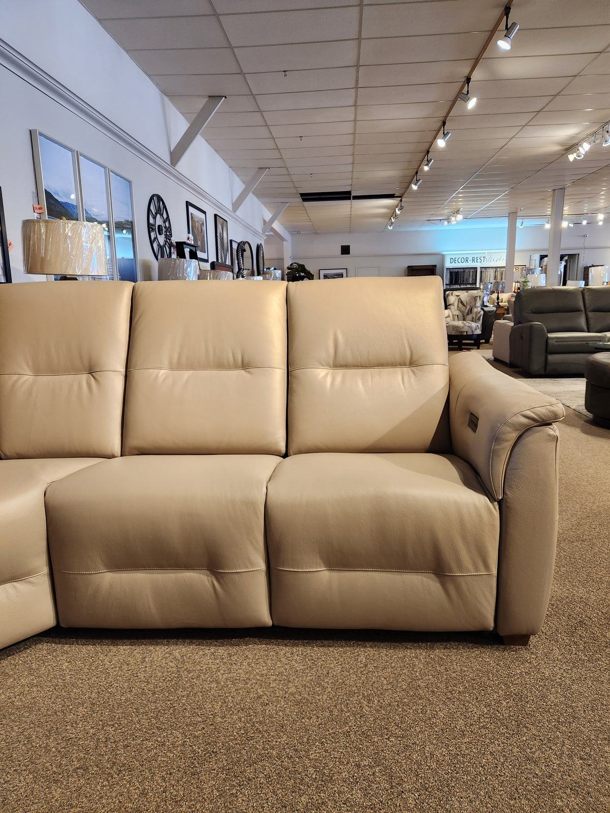 The Palliser Oxford 3-piece Sectional with power recline and adjustable headrest is shown on a carpeted showroom floor.