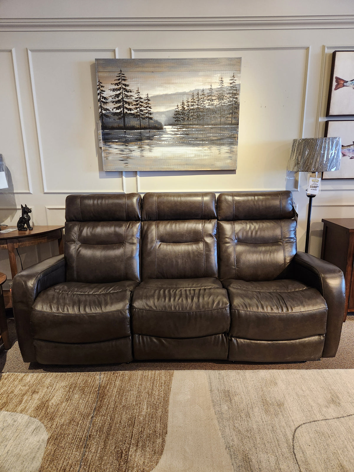 La-Z-Boy 807 Baron Reclining Sofa with lumbar support on display, landscape painting and side tables in background.