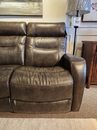 La-Z-Boy 807 Baron Reclining Sofa with visible stitching and lumbar support displayed next to a lamp in showroom.