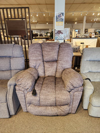 Best 6M52 Kona Power Lift Chair with overstuffed cushions and remote, shown in a furniture store showroom.