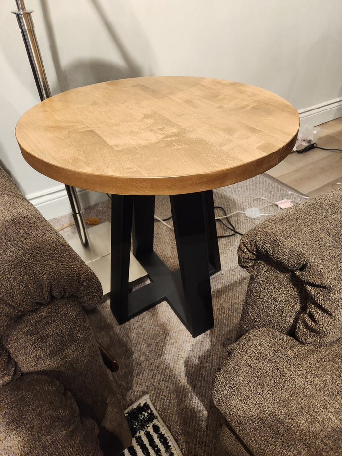 A Handstone Belmont Round End Table sits between two brown upholstered armchairs.