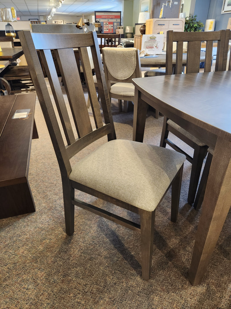 The Handstone Parker 7pc Dining Package offers stylish, space-saving seating with gray cushions—ideal for any showroom.