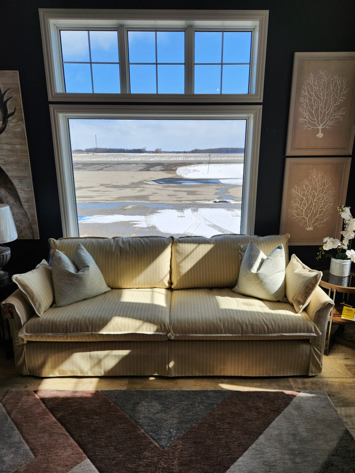Best Oxford Sofa with yellow stripes and down-blend cushions sits by a window with a snowy outdoor view.