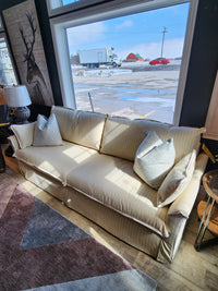 Best Oxford Sofa in cream with striped slipcover and down-blend seat cushion, placed on wooden flooring by a window.