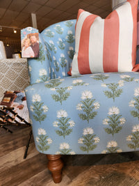 Arden Club Chair by Best: button-tufted blue with white floral print, striped pillow, and family photo on armrest.