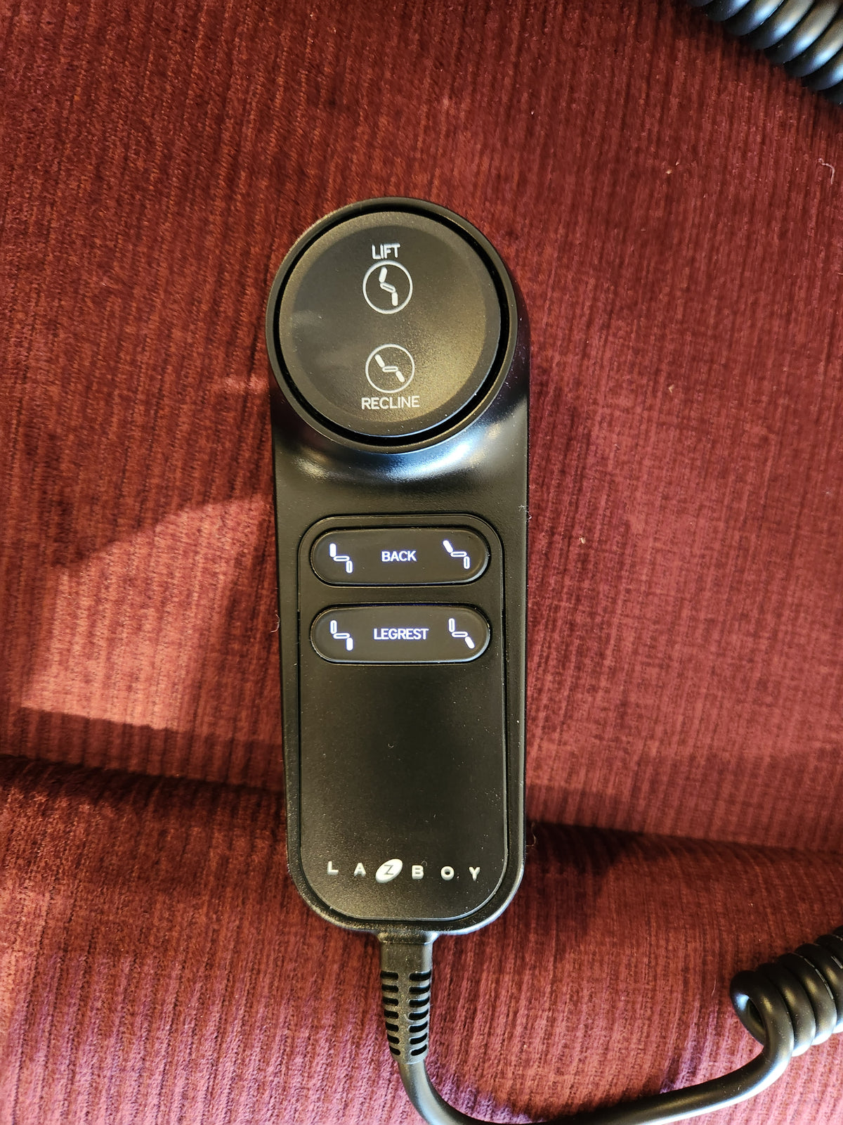 La-z-boy 512 Pinnacle Platinum Lift Chair remote controls lift, recline, back & leg rest on red upholstery.