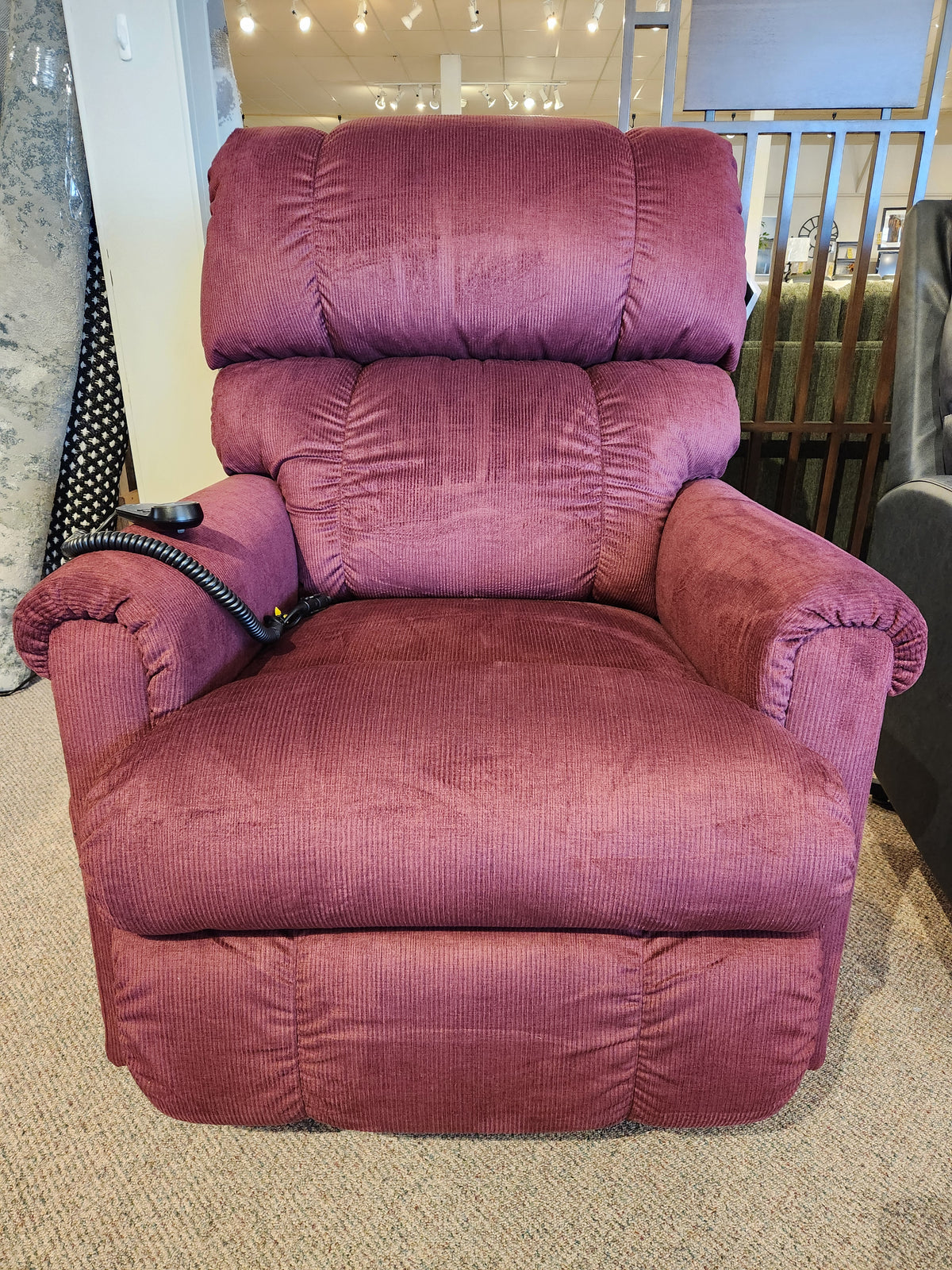 A La-z-boy 512 Pinnacle Platinum Luxury Lift Chair in burgundy with remote is displayed on a beige carpet.