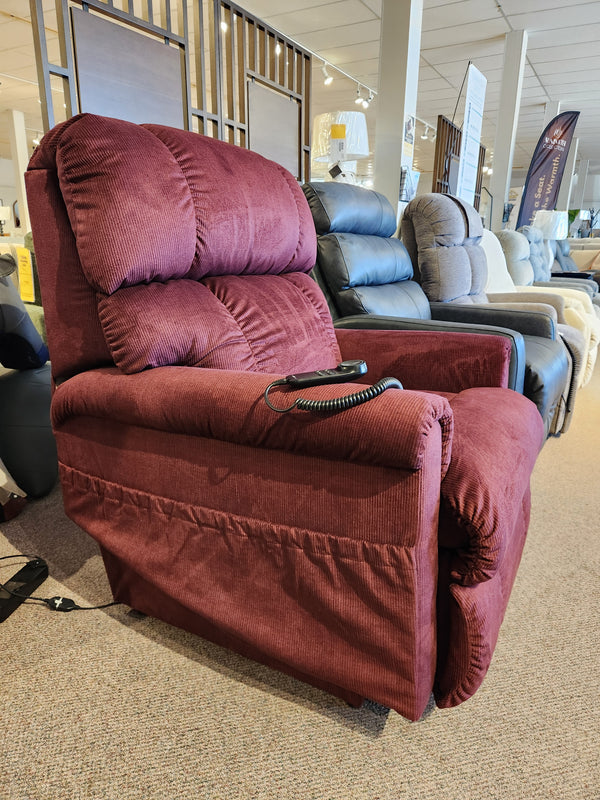 The La-z-boy 512 Pinnacle Platinum Luxury Lift Chair in red with remote is showcased among other recliners in the showroom.