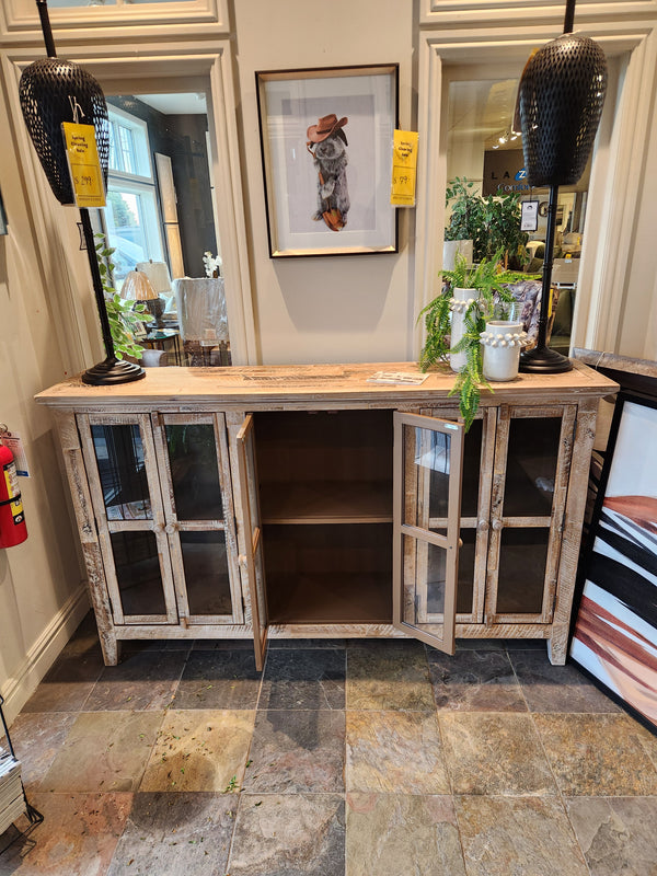 Jofran 2125 Rustic Shores 6 Door Accent Cabinet with glass doors open, black lamps, plants, and animal art on tile floor.