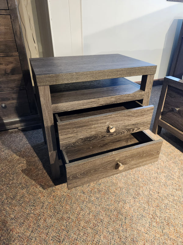 The Magnussen B6308 - Merrifield Nightstand with open shelf and two drawers sits on a carpeted floor.