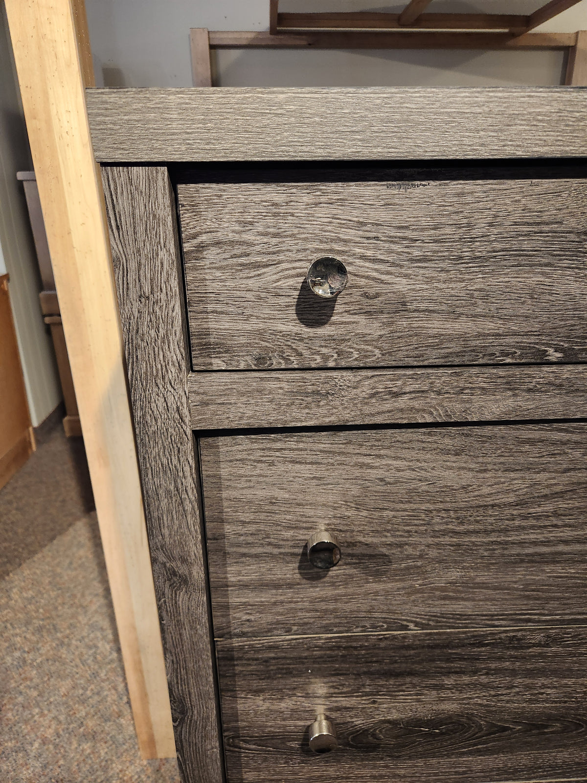 Close-up of a Magnussen B6308 - Merrifield Chest with a missing drawer knob, showing the hole where the knob should be.