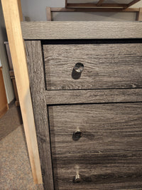 Close-up of a Magnussen B6308 - Merrifield Chest with a missing drawer knob, showing the hole where the knob should be.