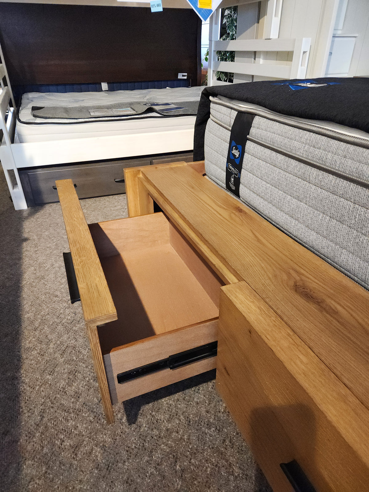 A Magnussen B6309 Davenport Queen Storage Bed in Rustic Caramel enhances this mid-century modern bedroom showroom.