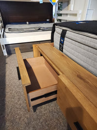 A Magnussen B6309 Davenport Queen Storage Bed in Rustic Caramel enhances this mid-century modern bedroom showroom.