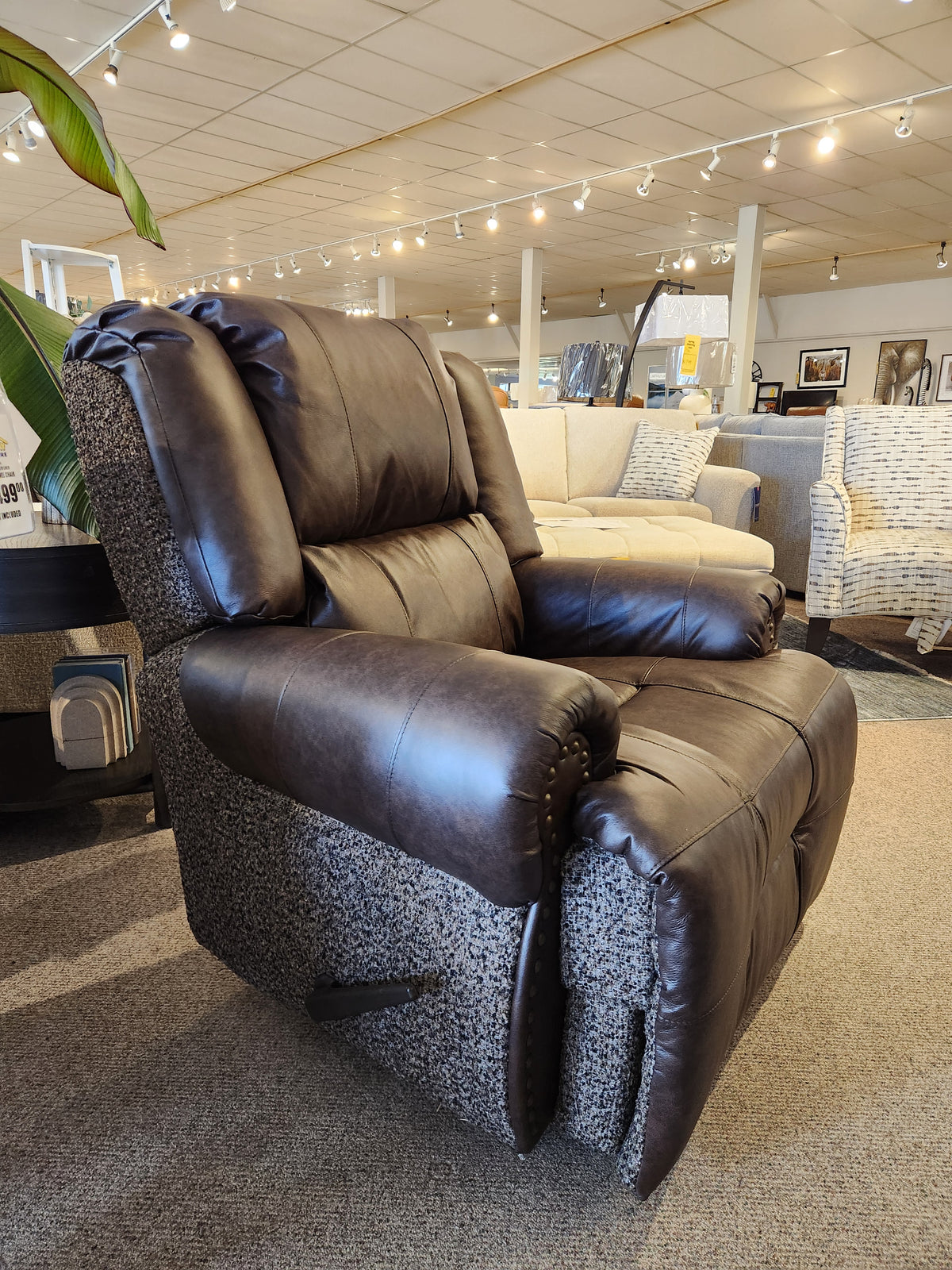 The FS9N64LF Garnet Reclining Chair by Best in brown and gray features a USB port, shown in a bright showroom.