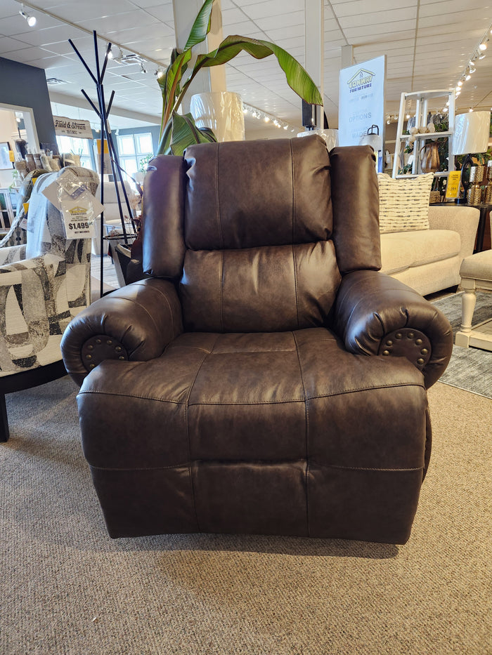 The Best FS9N64LF Garnet Reclining Chair is a dark brown power recliner with padded arms and USB port in the showroom.