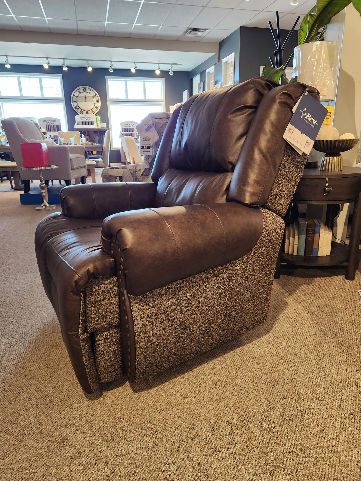 Best FS9N64LF Garnet Reclining Chair in brown and gray on display in a showroom with other chairs in the background.