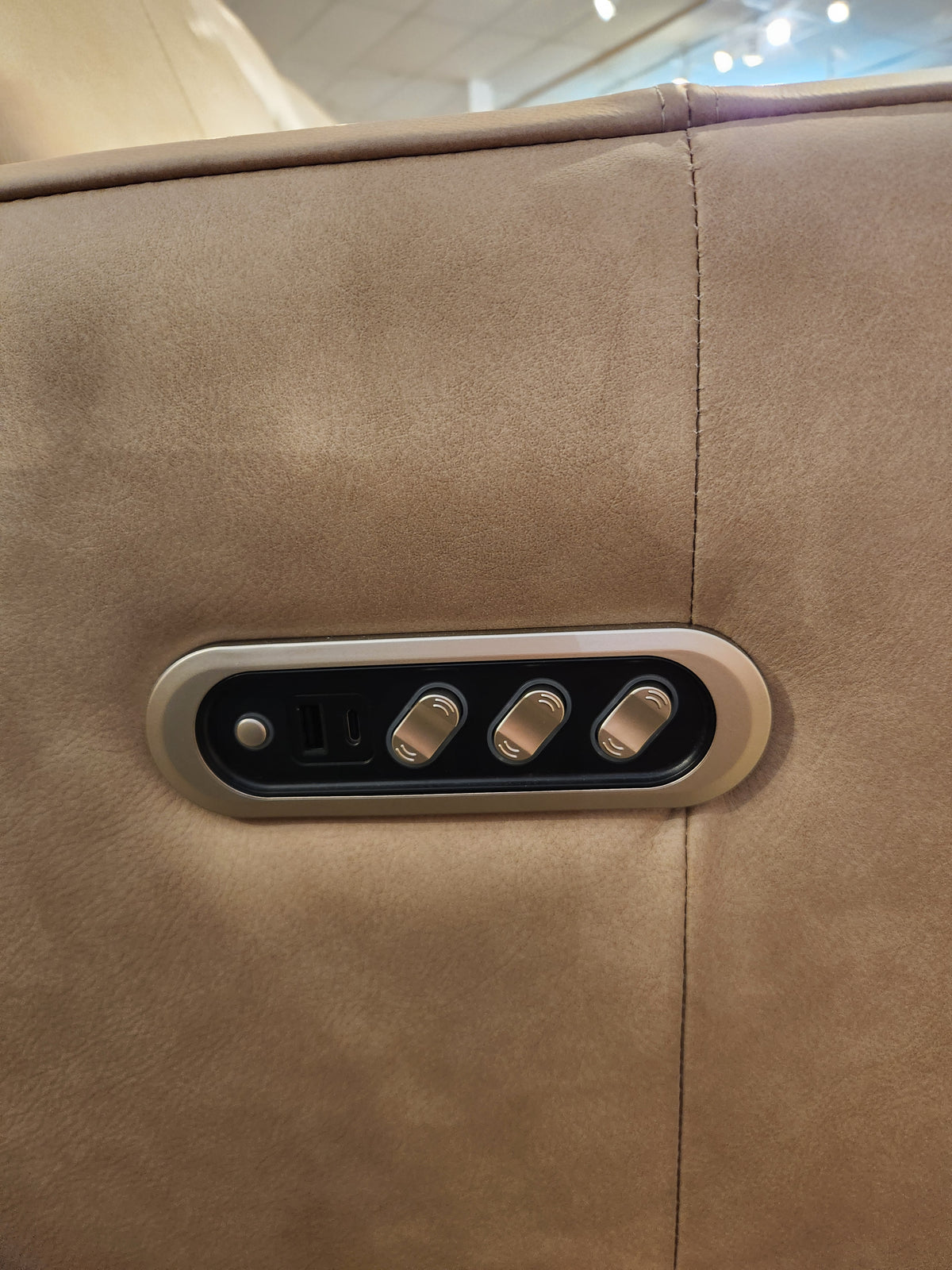 Close-up of the Decor-rest M8520 Power Reclining Sofa in beige with lumbar support, control panel, and USB port.