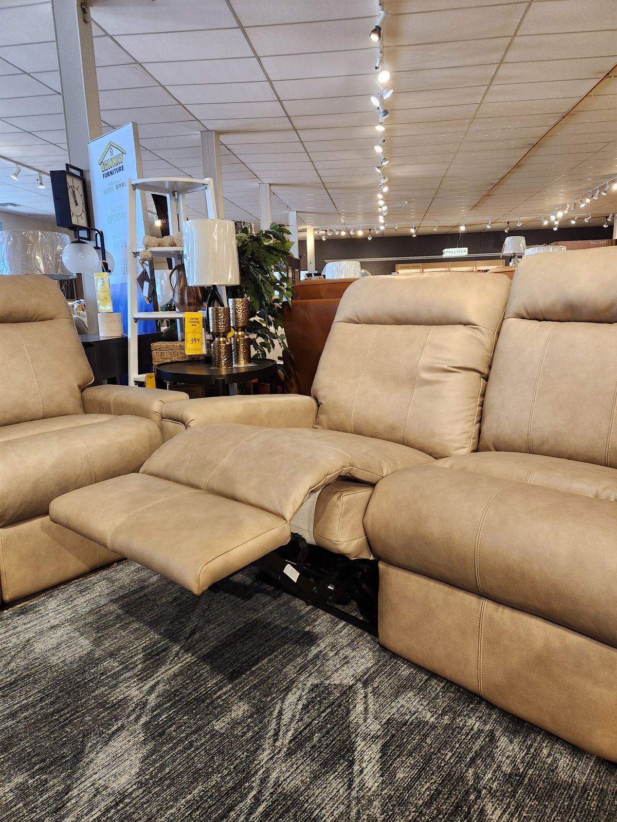The Decor-rest M8520 Power Reclining Sofa, beige, Canadian-made with adjustable lumbar support, shown in a showroom.