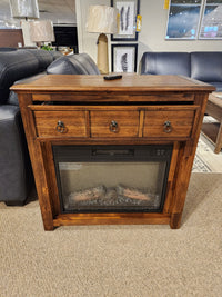 The Jofran 1900 Bakersfield 32" Fireplace features customizable flames and three drawers, shown with couches and decor.