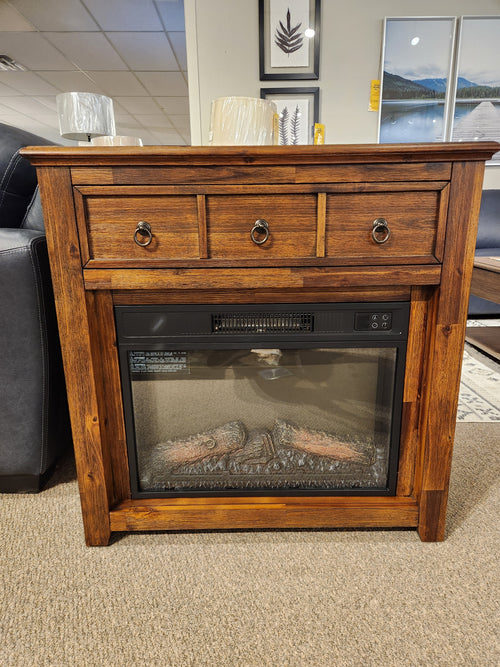 Jofran 1900 Bakersfield 32" Fireplace with three drawers and adjustable flame, displayed with framed art in showroom.