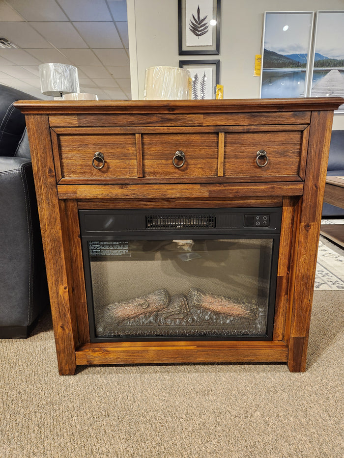 Jofran 1900 Bakersfield 32" Fireplace with three drawers and adjustable flame, displayed with framed art in showroom.