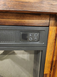 Close-up of Jofran's 1900 Bakersfield 32" Fireplace control panel with customizable flame, set in a wooden frame.