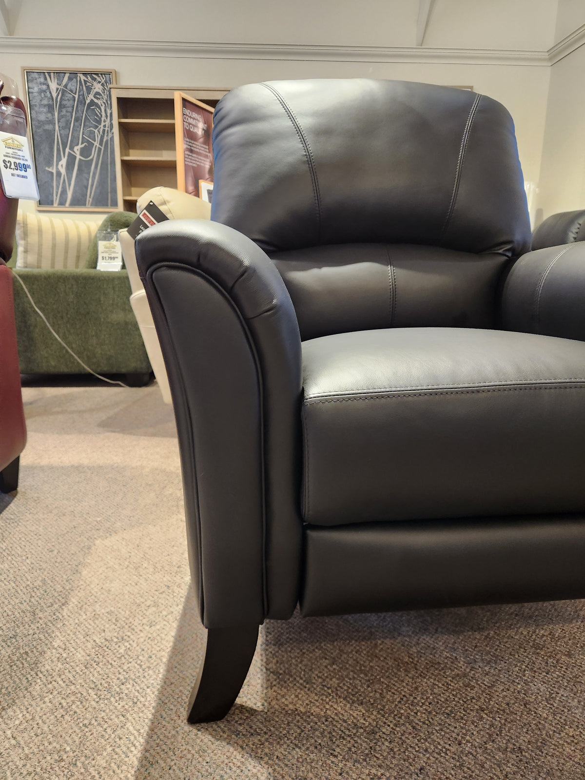 Leather Craft 698 Reclining Chair on a carpeted showroom floor, with other Canadian leather furniture in back.
