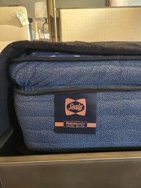 Close-up of a Sealy Roux ET Soft 1300 Coil Copper Series mattress with tag, offering pressure relief in-store.