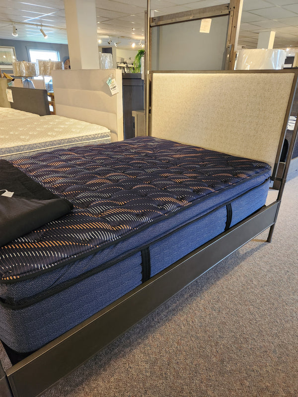 Sealy Roux ET Soft 1300 Coil Copper Series queen cooling mattress with blue cover, pressure relief on display.