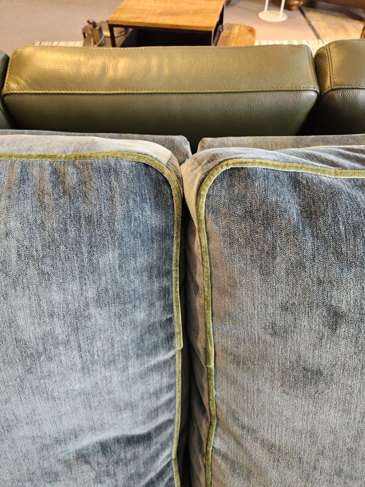 Close-up of two gray velvet cushions with green trim on the Adeline Sofa by Best, featuring reversible seat cushions.