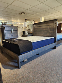 Sealy Cyra TT Firm 1000 Coil Copper Series mattress on display with other beds in a carpeted showroom.