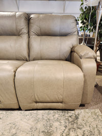 The Best Maverly S910 Space Saver Recliner Sofa in beige with plush cushions and Tilt Headrest is shown in a showroom.