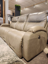 Best Maverly S910 Space Saver Recliner Sofa in beige leather, displayed with overhead lighting and a patterned rug.
