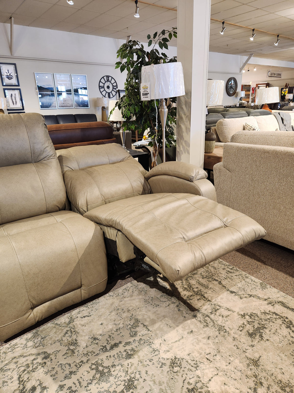 Best Maverly S910 Space Saver Recliner Sofa in light beige, featuring tilt headrest, displayed among sofas and decor.