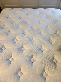 Close-up of the Springwall Michelle ET Medium Mattress with a quilted white cover and circular pattern.