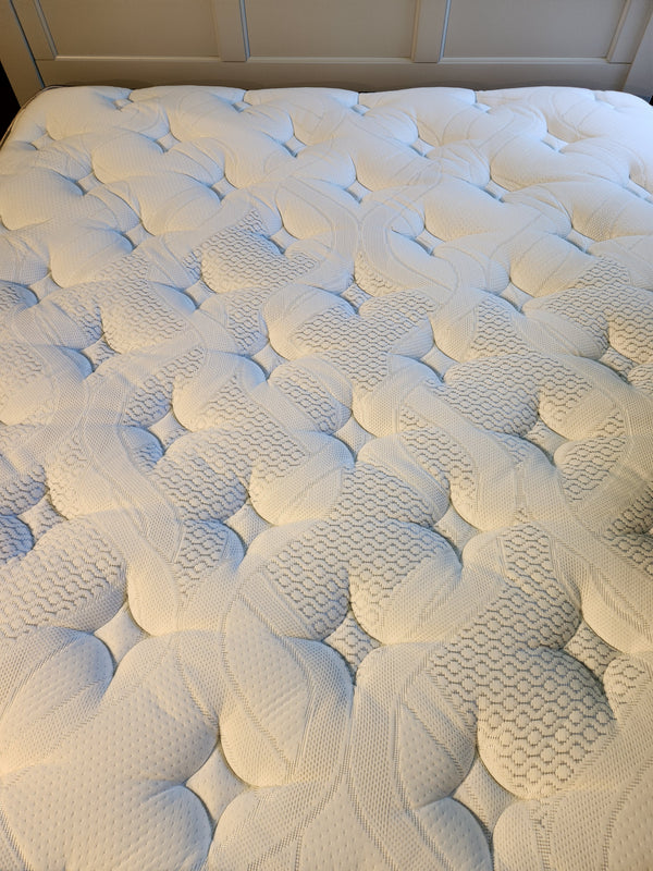 Close-up of the Springwall Michelle ET Medium Mattress with a quilted white cover and circular pattern.