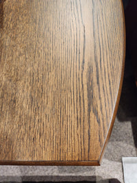 Close-up of the Magnussen T6385 - Phoebe Rectangular End Table in Sienna Brown with grain patterns and curved edge.