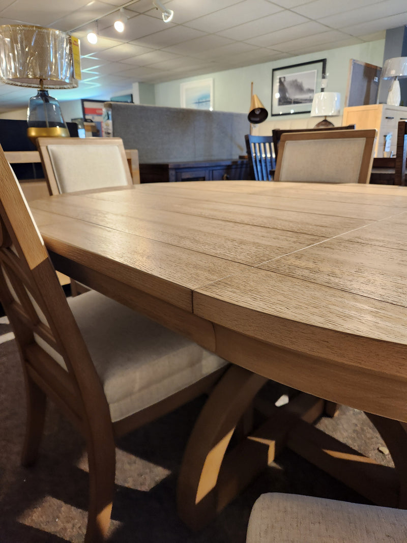 Magnussen D6480-Coventry 7pc Dining Set in Honey Maple with cushioned chairs, displayed among home décor.