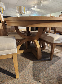 The Magnussen D6480-Coventry 7pc Dining Set features a honey maple finish and curved pedestal base with upholstered chairs.
