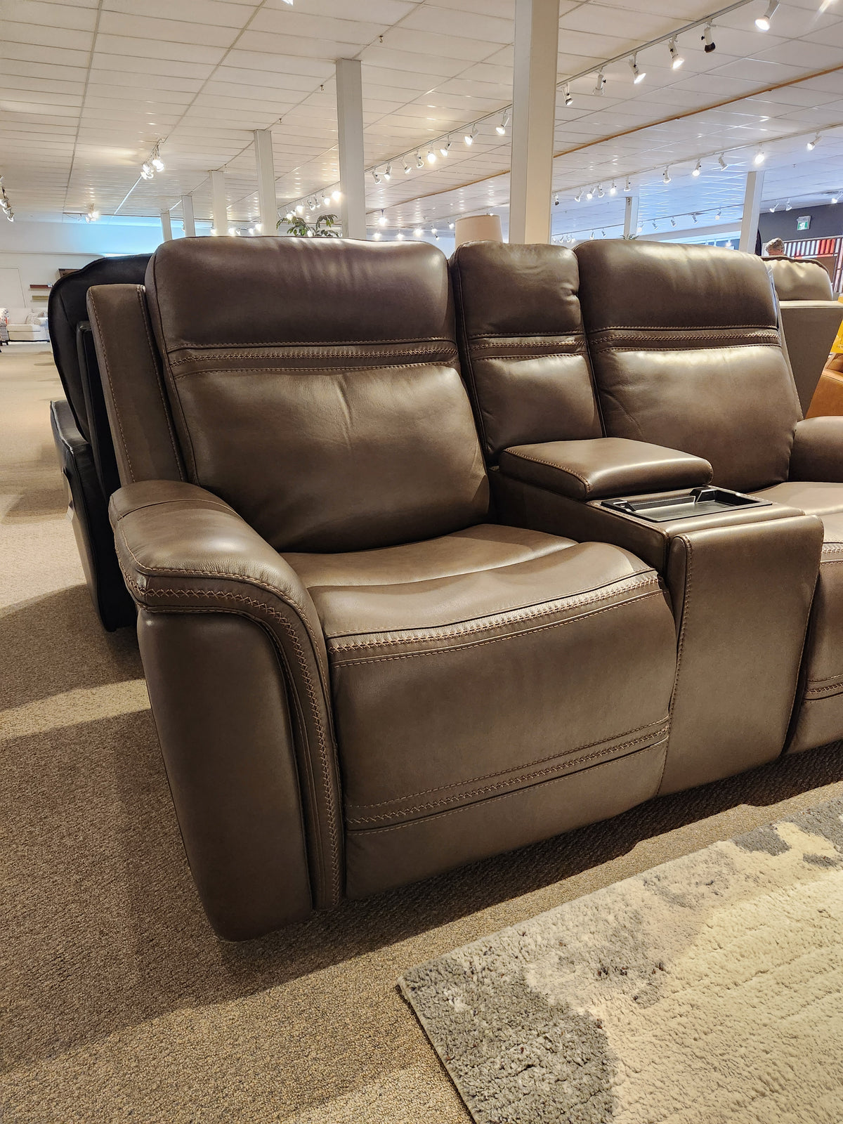 Donald Choi San Antonio Power Recliner Loveseat-520356 with cup holders and adjustable headrest in a bright showroom.