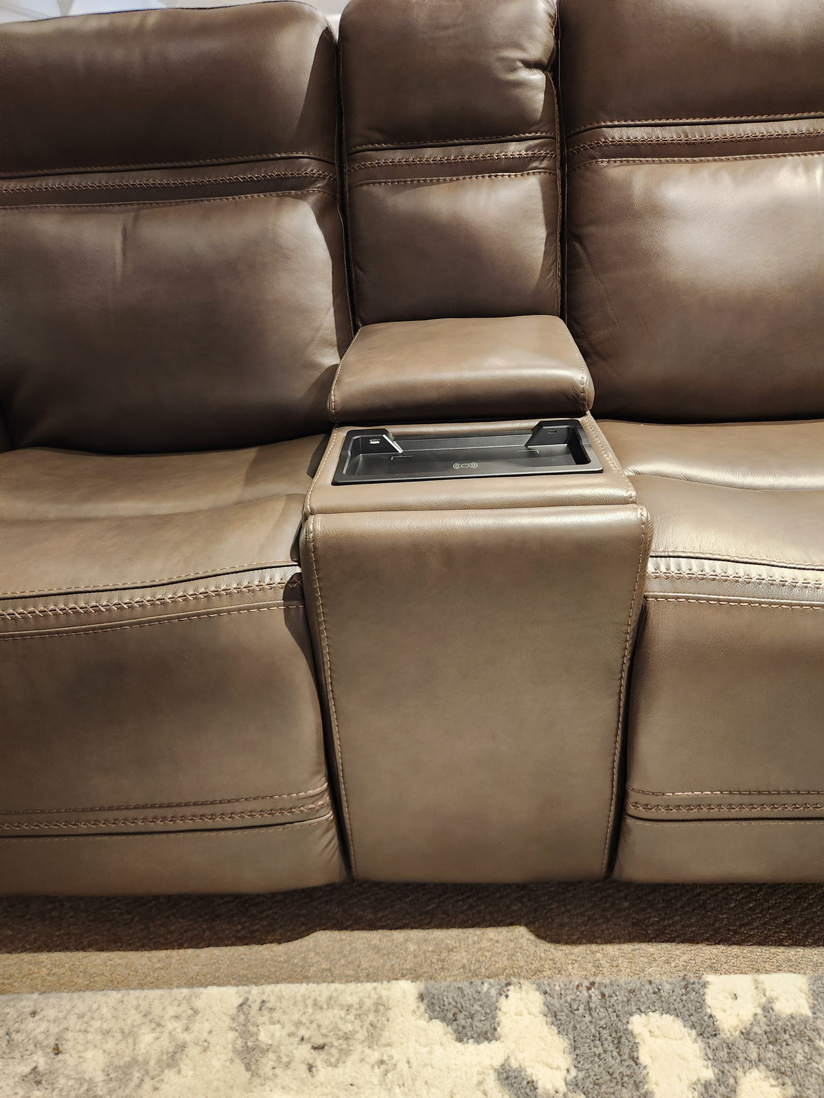 Donald Choi San Antonio Power Recliner Loveseat-520356 with armrest, cup holders, and adjustable headrest on carpet.
