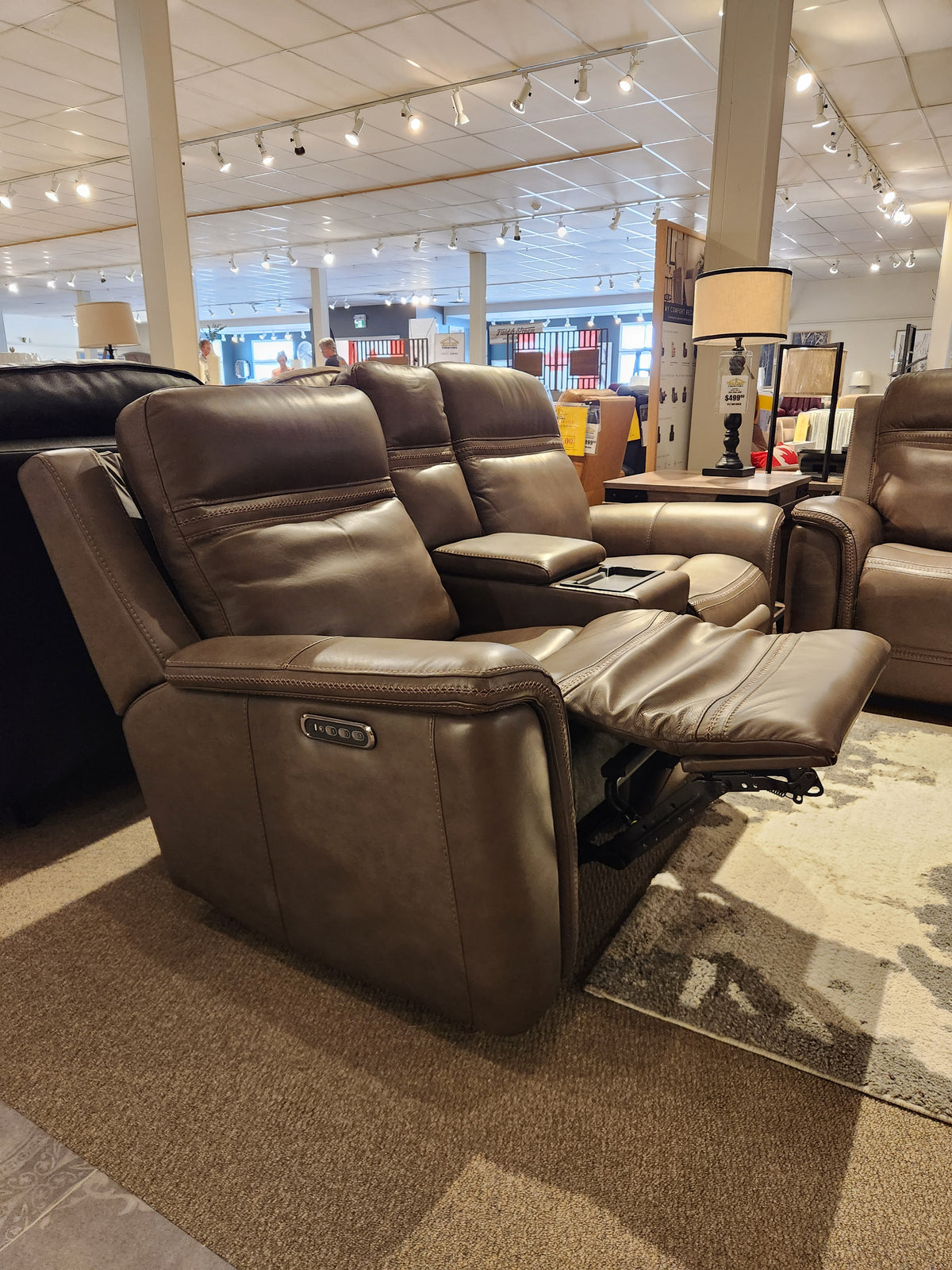 Donald Choi San Antonio Power Recliner Loveseat-520356 with cup holders and adjustable headrest shown in showroom.
